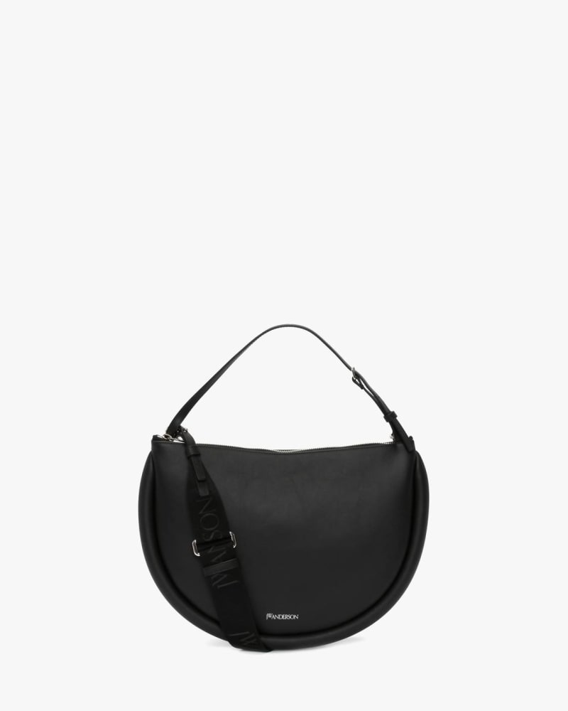 Front of a model wearing a size O/S Medium Bumper-Moon Leather Crossbody Bag in Black in Black by JW Anderson. | dia_product_style_image_id:343370